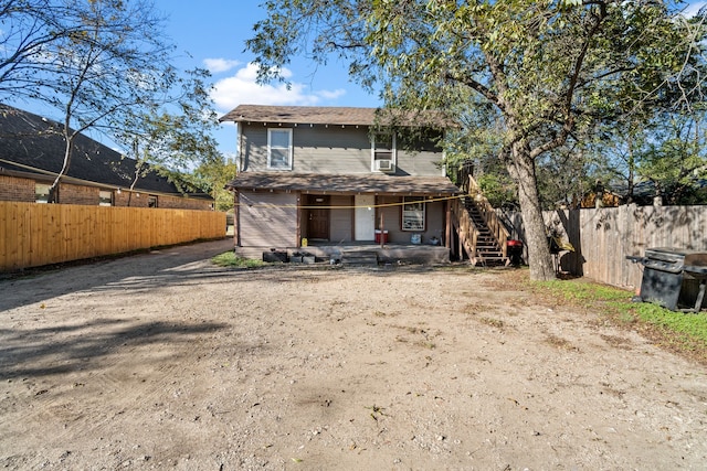 rear view of property with a porch