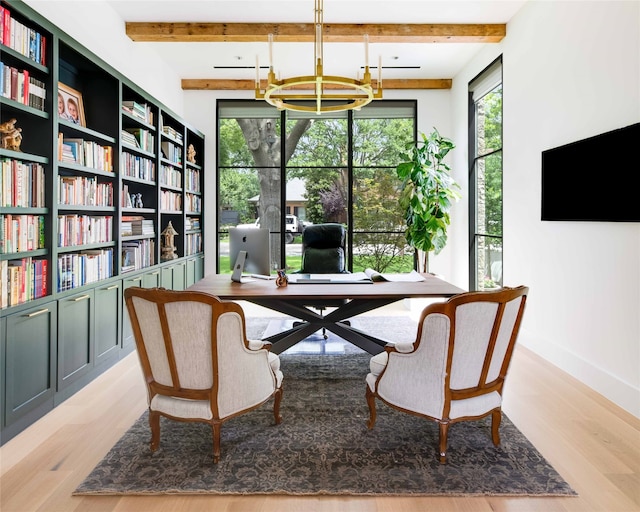 sitting room with a chandelier, beam ceiling, and light hardwood / wood-style flooring