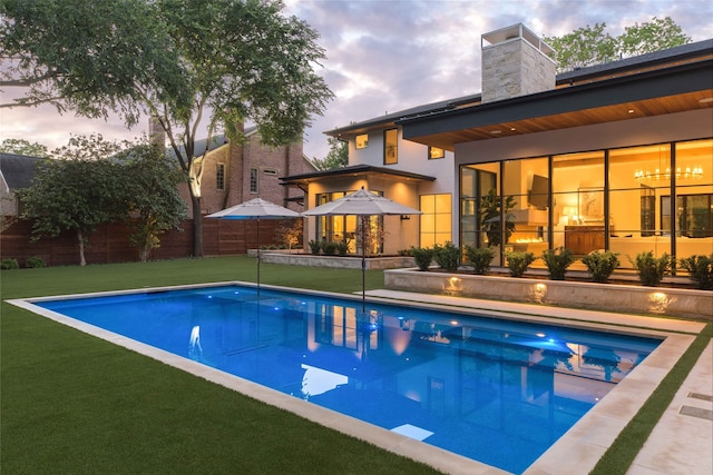 pool at dusk with a lawn