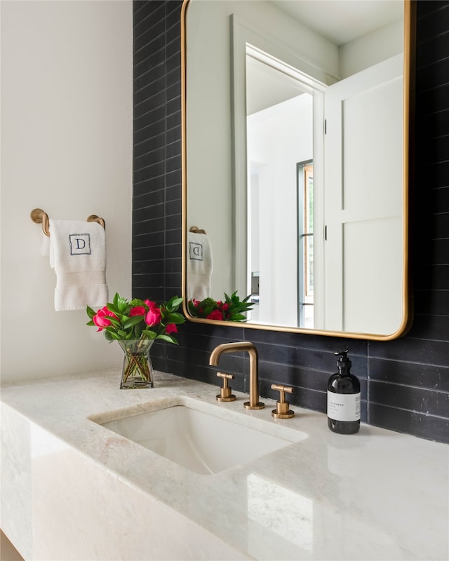 bathroom featuring vanity and backsplash