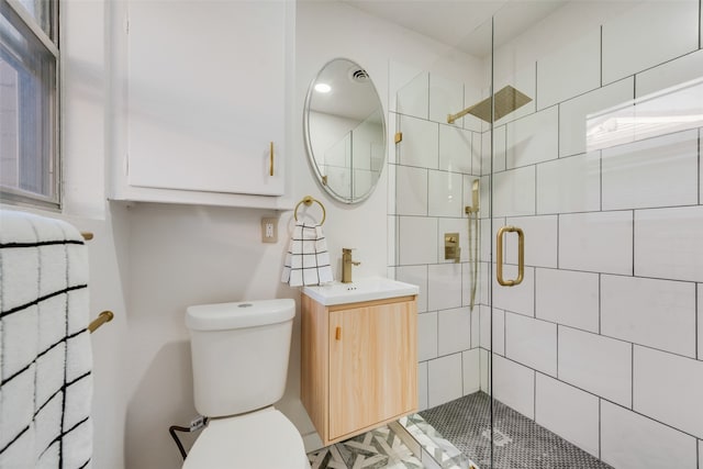 bathroom featuring an enclosed shower, vanity, and toilet