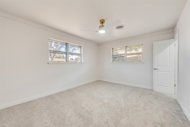 spare room with carpet flooring, a healthy amount of sunlight, and ornamental molding