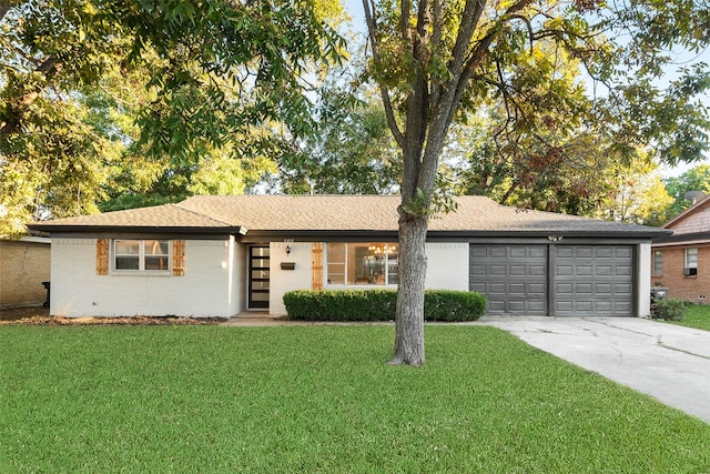 single story home featuring a front lawn and a garage