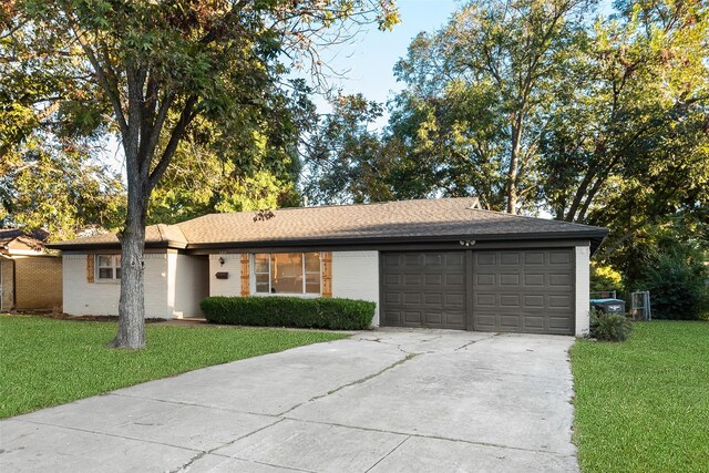 ranch-style home featuring a front yard and a garage