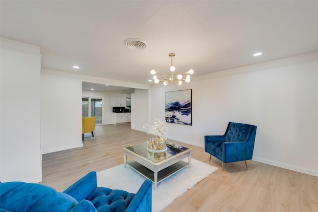 living room featuring a brick fireplace, ceiling fan with notable chandelier, and light hardwood / wood-style flooring