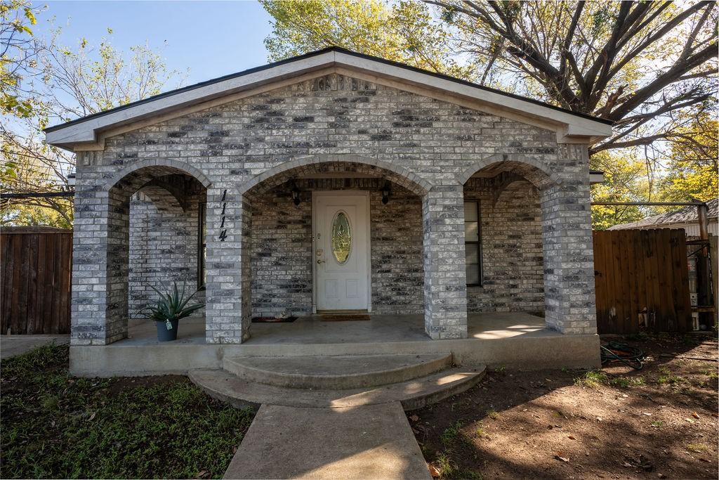 1114 Alexander St, Irving, TX 75061 - view of front facade with a porch and brick siding
