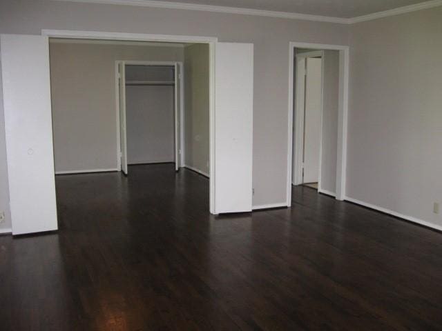 unfurnished bedroom with dark hardwood / wood-style floors and crown molding