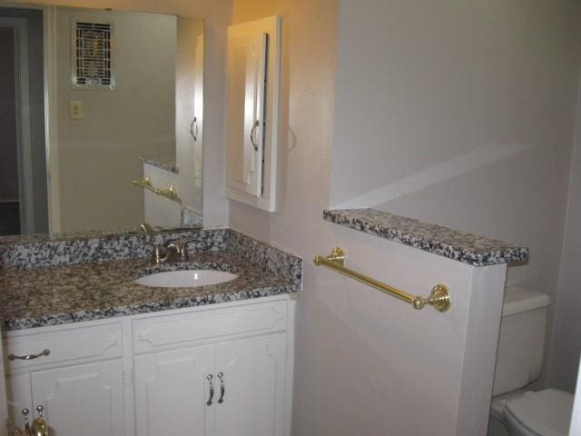 bathroom with vanity and toilet