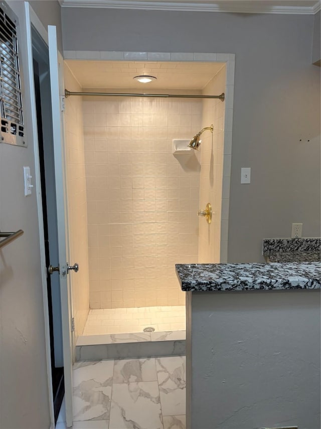 bathroom with tiled shower and ornamental molding