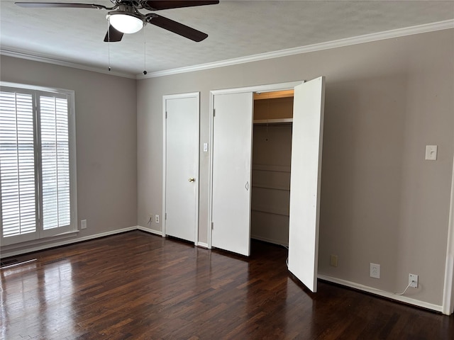 unfurnished bedroom featuring dark hardwood / wood-style floors, ceiling fan, and crown molding