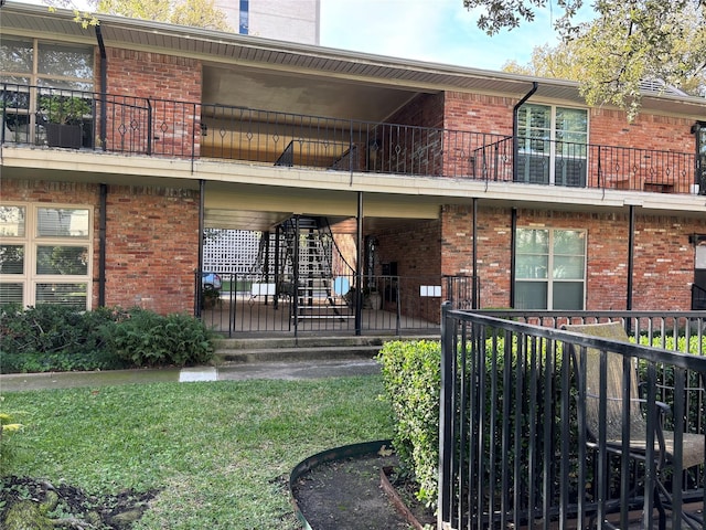 rear view of property featuring a balcony