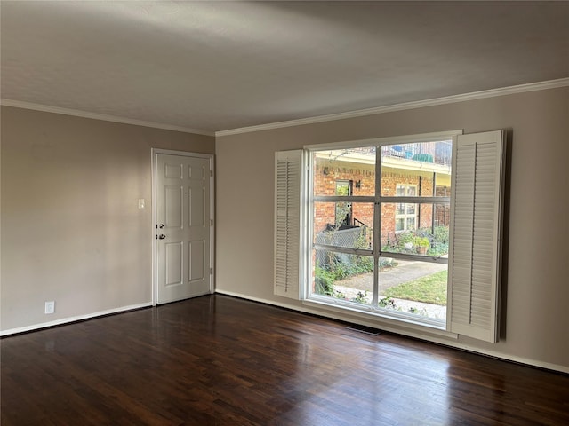 empty room with dark hardwood / wood-style floors and crown molding