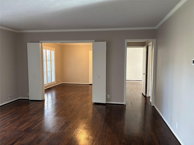 spare room with dark wood-type flooring and ornamental molding