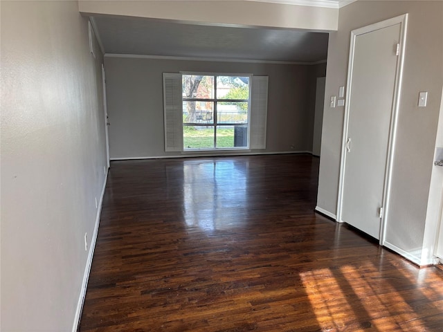 empty room featuring dark hardwood / wood-style floors and crown molding