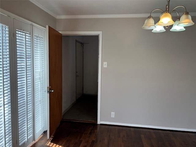 interior space with dark hardwood / wood-style floors, crown molding, and an inviting chandelier