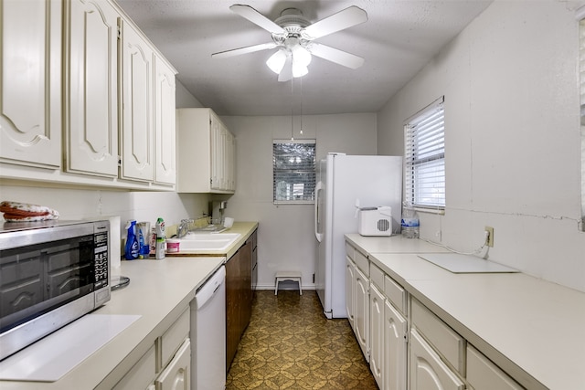 kitchen featuring white cabinets, white appliances, ceiling fan, and sink