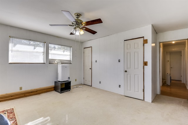 interior space with ceiling fan