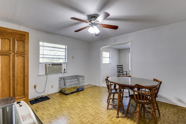 dining room with light parquet floors, plenty of natural light, cooling unit, and ceiling fan