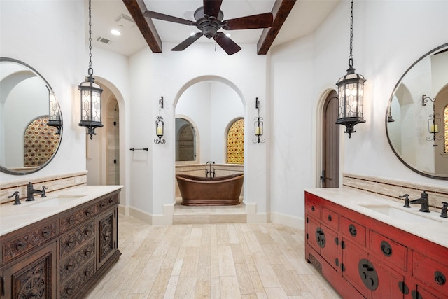 bathroom featuring visible vents, a sink, and beamed ceiling