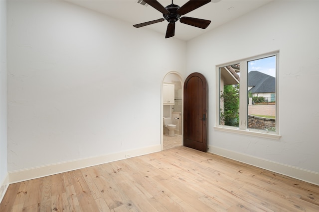 spare room with ceiling fan and light wood-type flooring