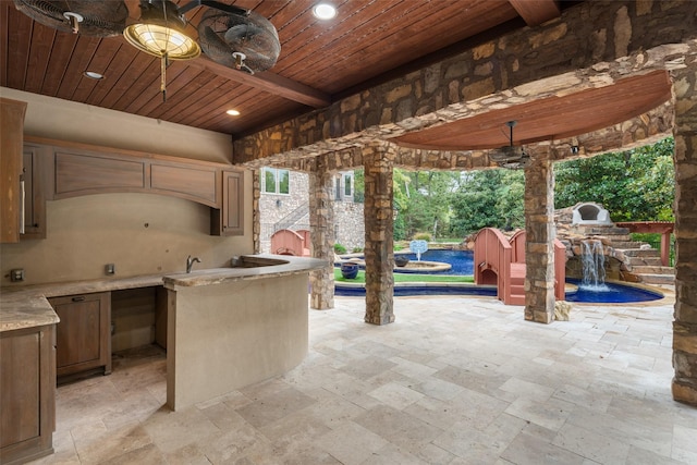 view of patio featuring an outdoor kitchen and a ceiling fan