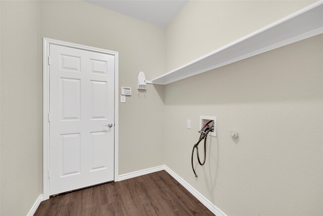 clothes washing area with dark wood-type flooring and hookup for a washing machine