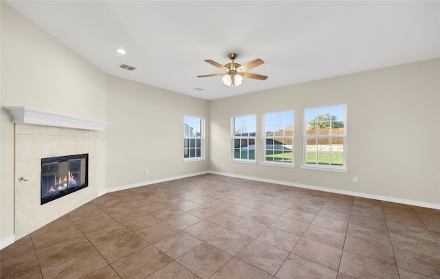 unfurnished living room featuring light tile patterned flooring, ceiling fan, and a tile fireplace