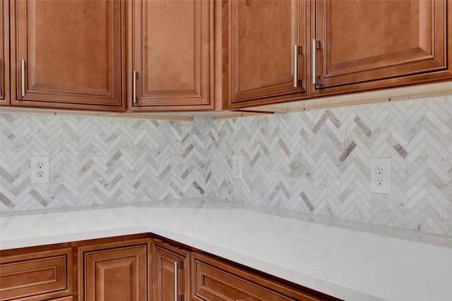 kitchen with tasteful backsplash and light stone counters