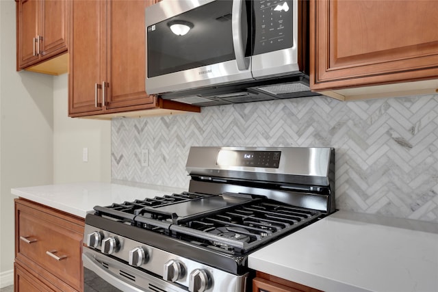 kitchen with stainless steel appliances and tasteful backsplash