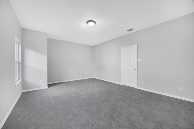 empty room with dark colored carpet