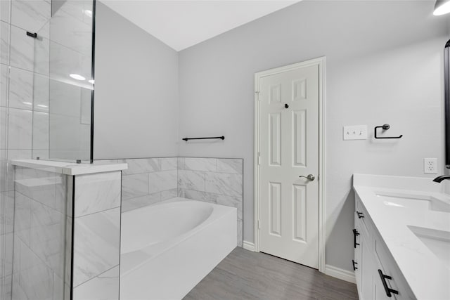 bathroom with vanity, wood-type flooring, and plus walk in shower