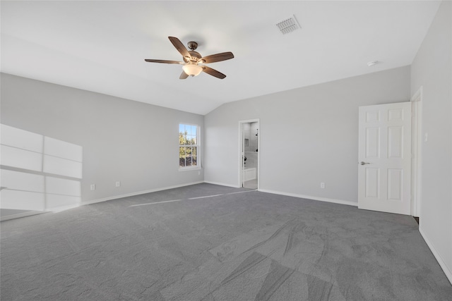 carpeted spare room with vaulted ceiling and ceiling fan