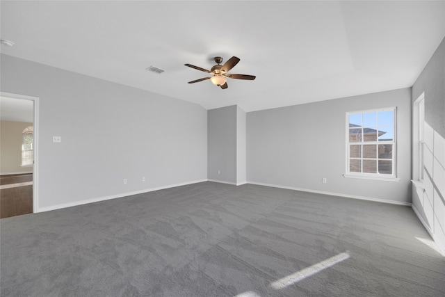 interior space with ceiling fan, carpet, and a wealth of natural light