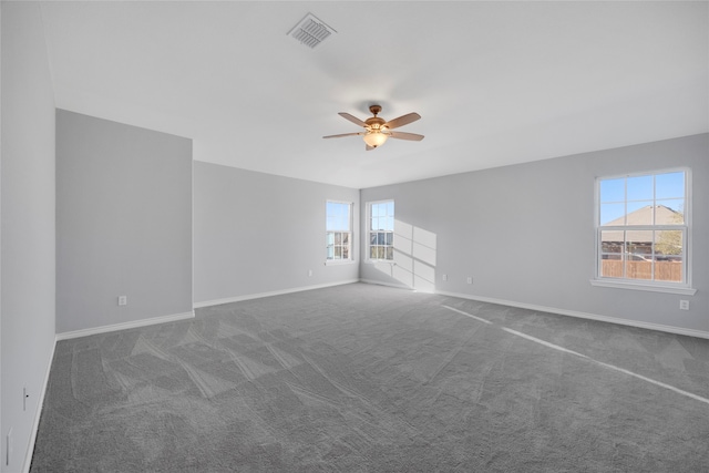 carpeted spare room featuring ceiling fan