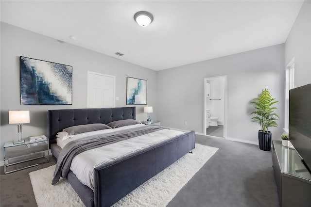 carpeted bedroom featuring ensuite bath