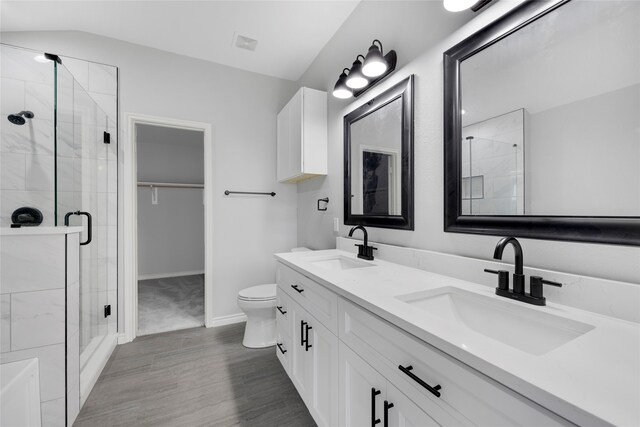 bathroom featuring walk in shower, vanity, and toilet