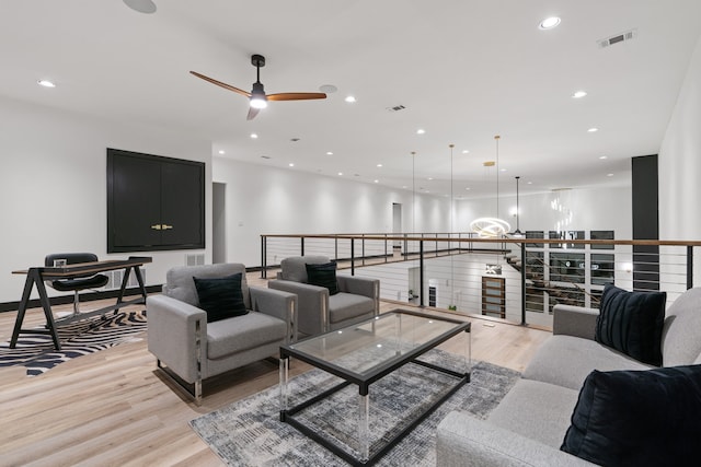 living room featuring light wood-type flooring and ceiling fan