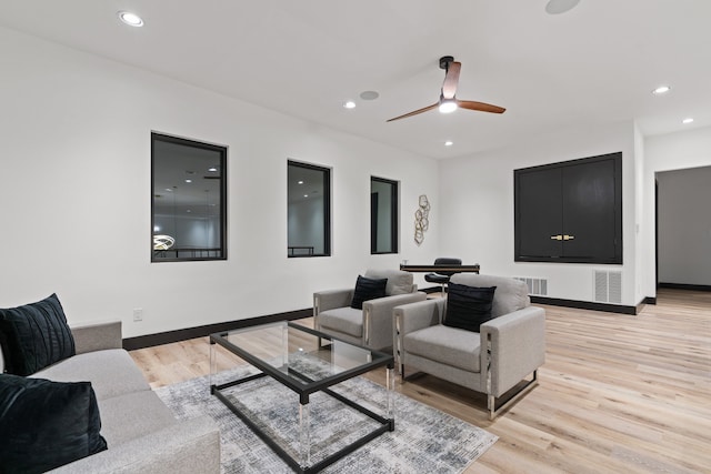 home theater with ceiling fan and light hardwood / wood-style floors