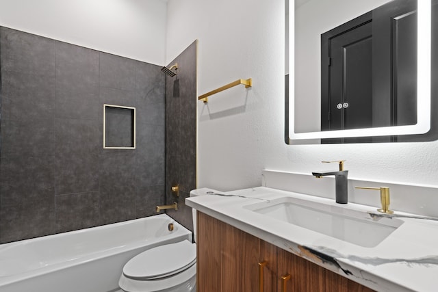 full bathroom featuring vanity, tiled shower / bath combo, and toilet