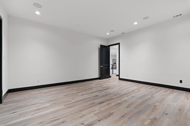 empty room with light hardwood / wood-style floors