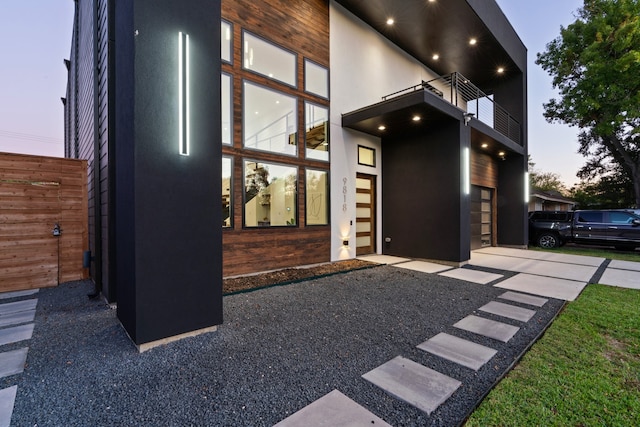 exterior space featuring a balcony and a garage