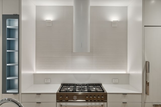 kitchen with white cabinetry and stainless steel stove