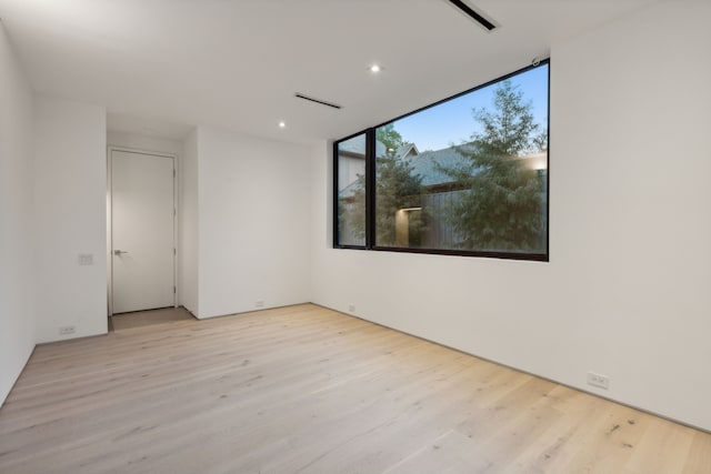 empty room with light hardwood / wood-style floors