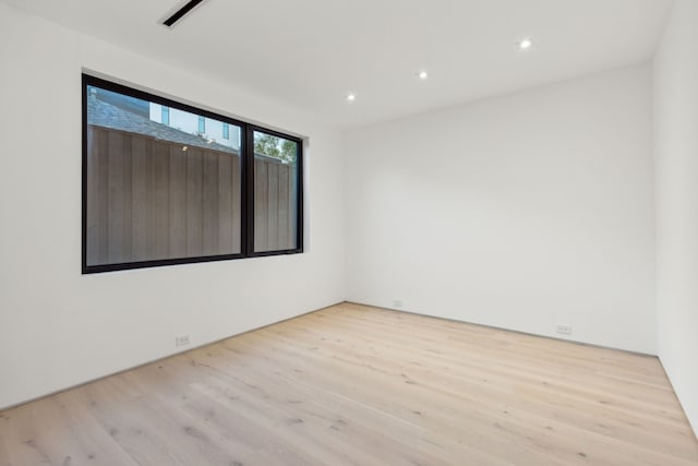 unfurnished room with light hardwood / wood-style floors