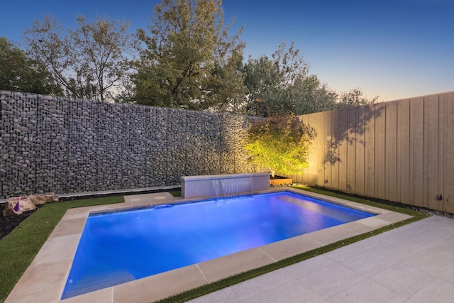 view of pool at dusk