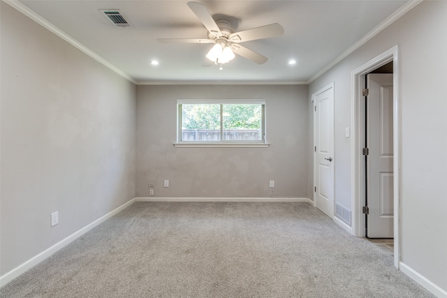 spare room with light carpet, ceiling fan, and ornamental molding