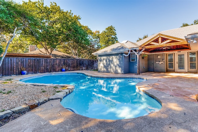 view of pool with a patio area and ceiling fan