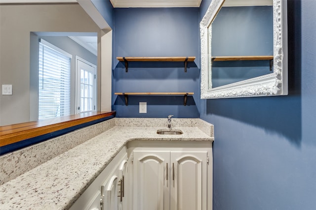 bathroom with vanity and ornamental molding