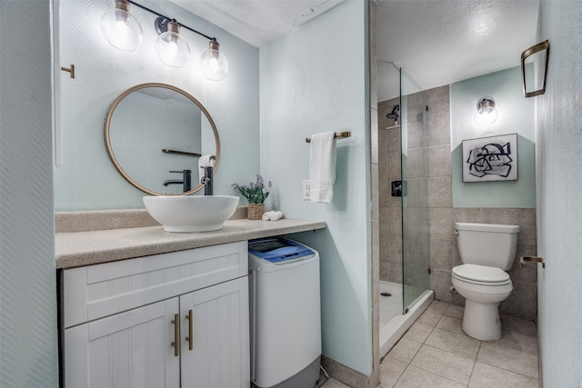 bathroom featuring vanity, tile patterned flooring, toilet, tile walls, and a textured ceiling