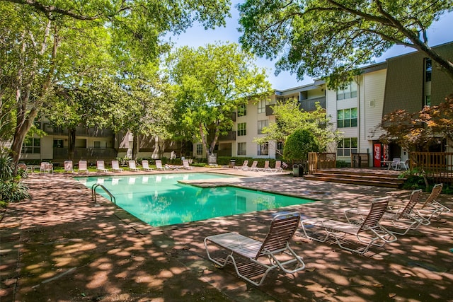 view of swimming pool featuring a patio area